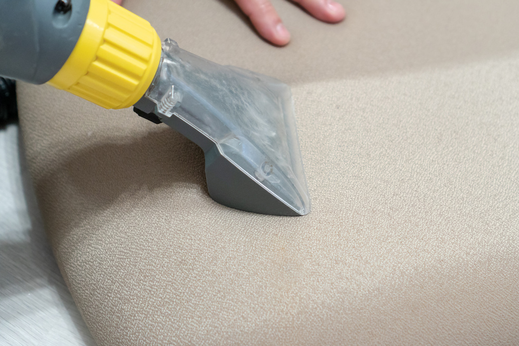 Manual cleaning of furniture with a steam cleaner. House cleaning concept. Before and after deep cleaning of furniture upholstery with a device